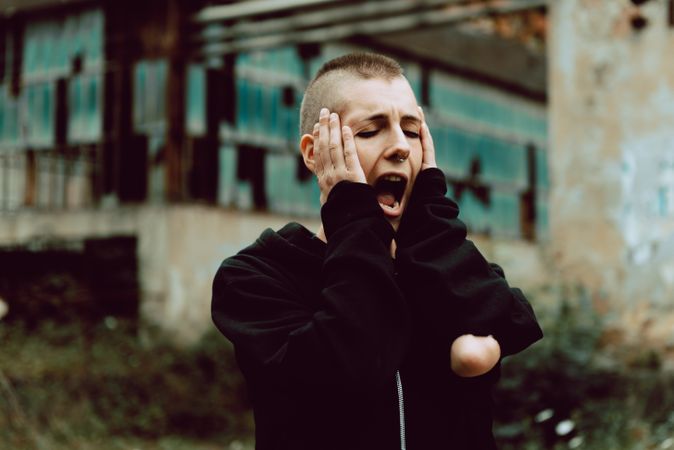 Stressed woman screaming on street