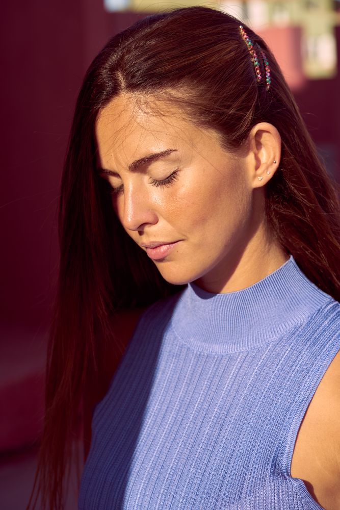 Woman looking at camera in sunlight