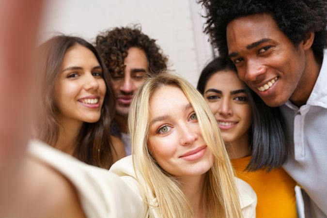 Happy group of friends taking a selfie outside