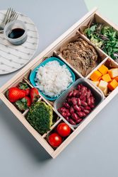 Food box with diet ingredients by copybook and plate