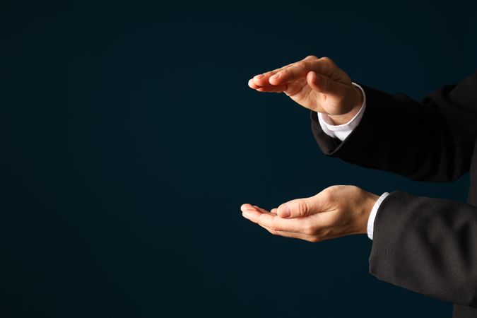 Businessman's hand close-up on a dark background