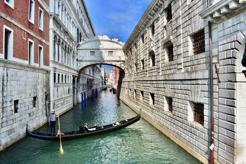 Man standing on a gondola in Venice, Italy 
