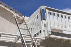 Construction Ladder Leaning on House Deck