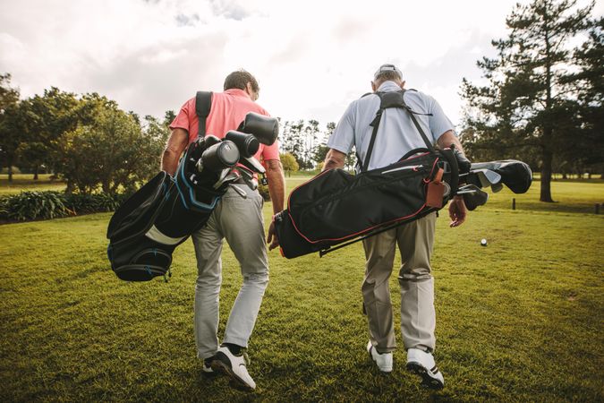 Mature golfers walking out of the course after a round of golf