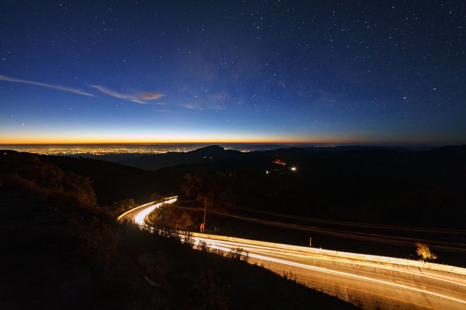 Milky way galaxy with stars and space dust in the universe and lighting on the road before morning at Doi inthanon Chiang mai, Thailand