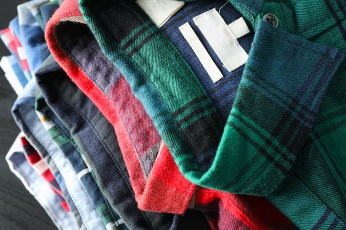 Stack of different shirts on table, close up