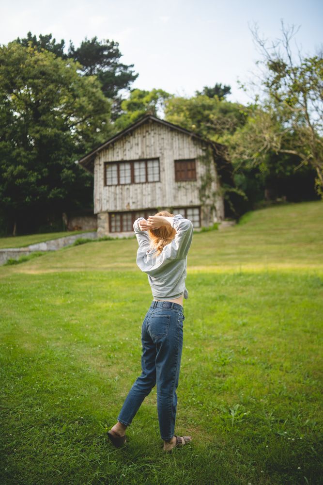 Content female walking on grass in countryside