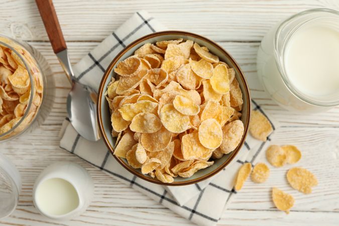 Concept of breakfast with muesli and milk on wooden table