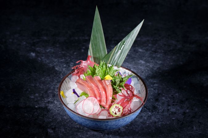 Ceramic plate with raw fish and vegetables