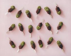 Ice cream chocolate pistachio popsicles, pink background