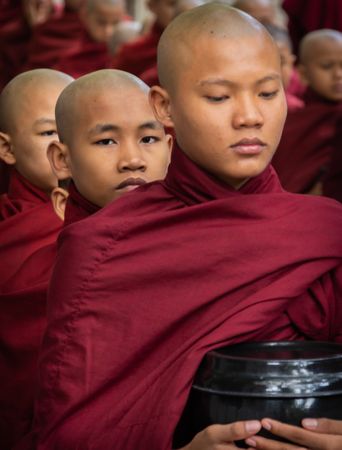 Mandalay, Myanmar - June, 25 2012: Monk boys standing in queue for food