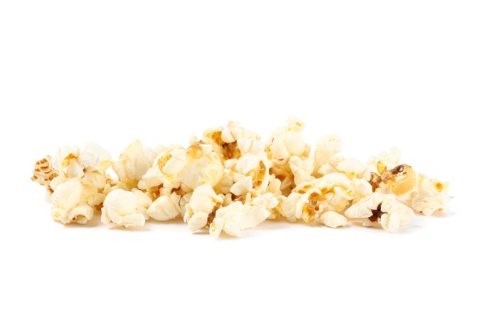 Popcorn pile isolated on blank background, close up