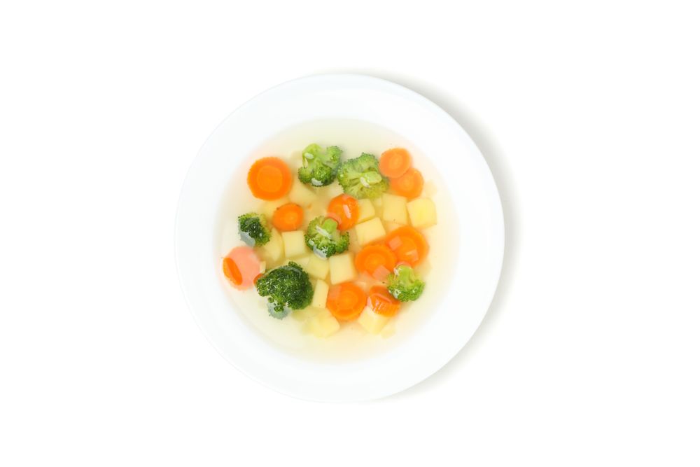 Lookin down at vegetable soup in blank studio shoot