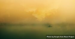 Silhouette of person in paddle boat in mist 49exB4