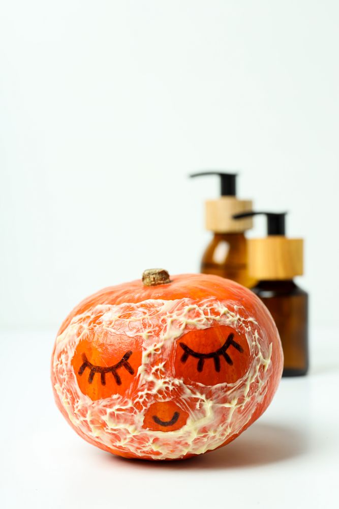 Skin care and face care concept - pumpkin cosmetic