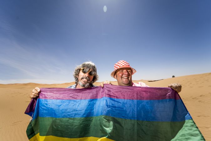 Excited gay couple in desert