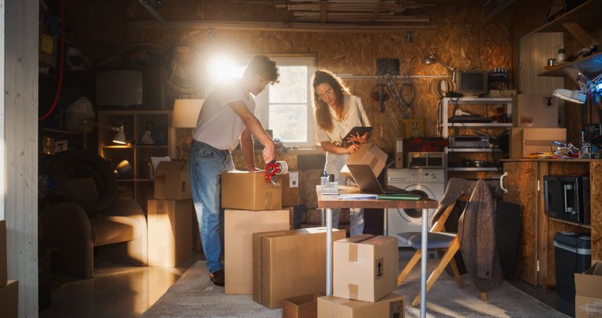 Diverse e-Commerce Business Partners Working in Garage And Talking.