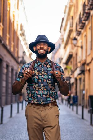 Stylish Black man walking on the city street