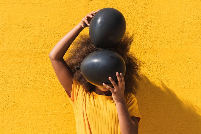 Black girl with black balloons