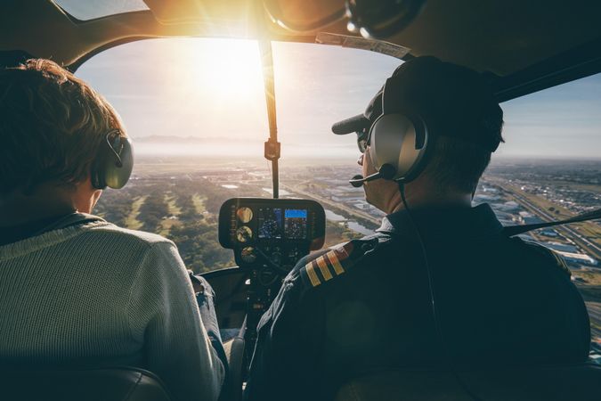 Man and woman flying in a helicopter