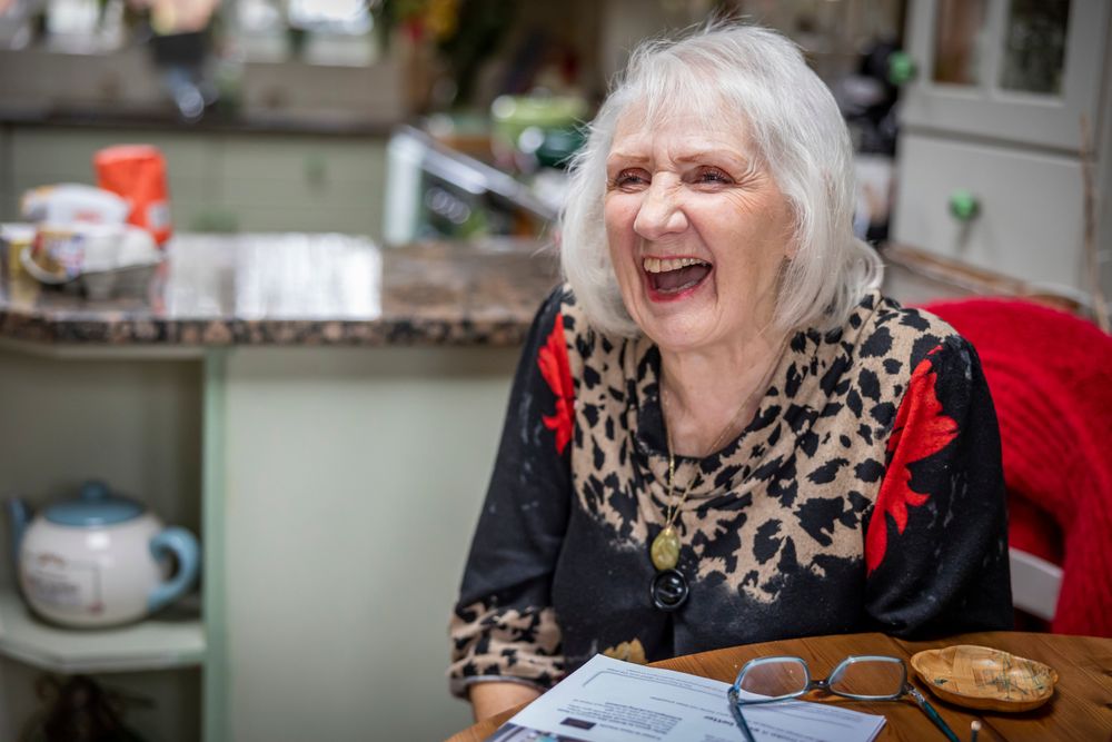 Woman laughing at table