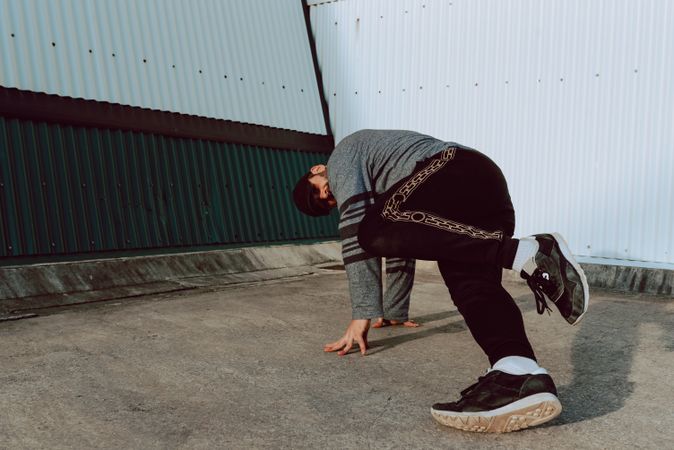 Man performing handstand near wall