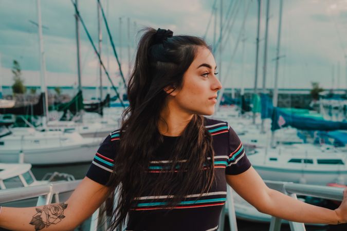 Smiling female walking standing on busy urban pier