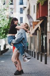 Happy lesbian couple having fun on street