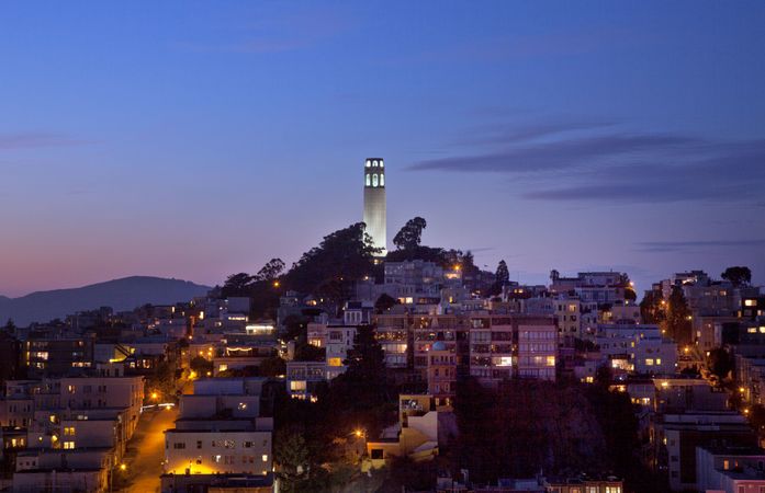 Coit tower lit up at dusk in San Francisco
