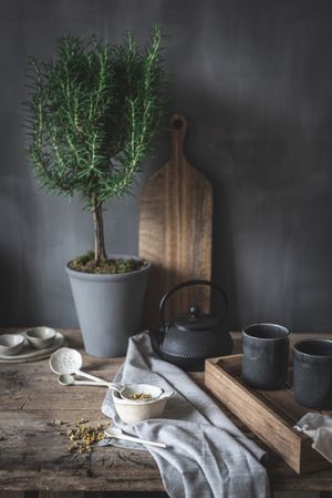 Round teapot and spoons with bowl on linen cloth