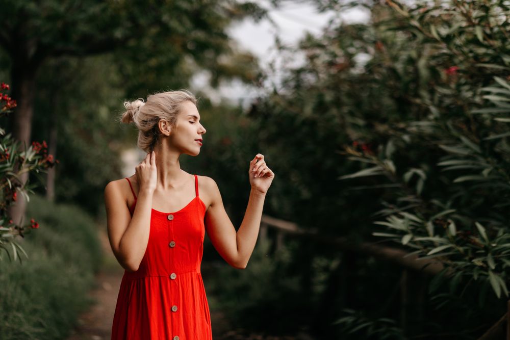 Dreamy young woman in summer garden