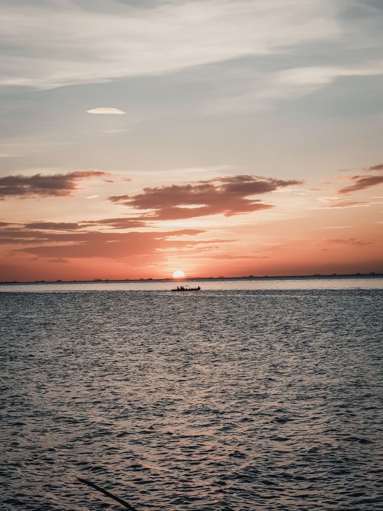 Sun setting behind ocean