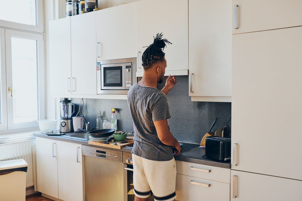 Young Black male cooking dinner