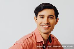 Headshot of smiling Hispanic male looking at camera in grey studio, copy space 5RgXA4