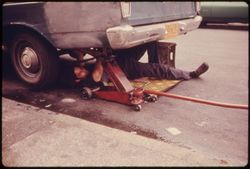 Man Working on Car in Hell's Kitchen, New York City