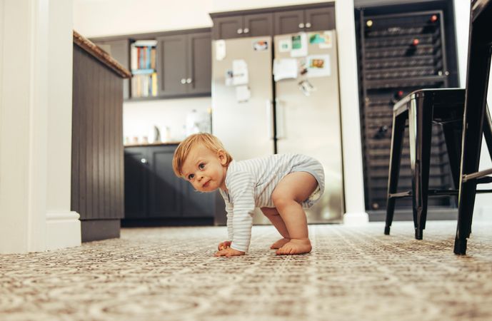 Developing child standing up on floor at home