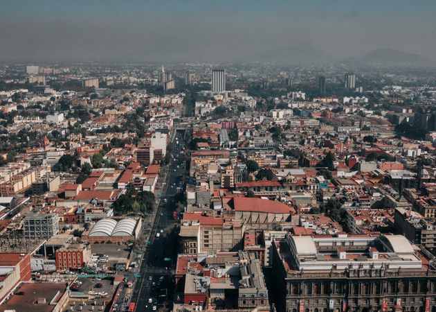 Looking down at roads and buildings in Mexico City on overcast day