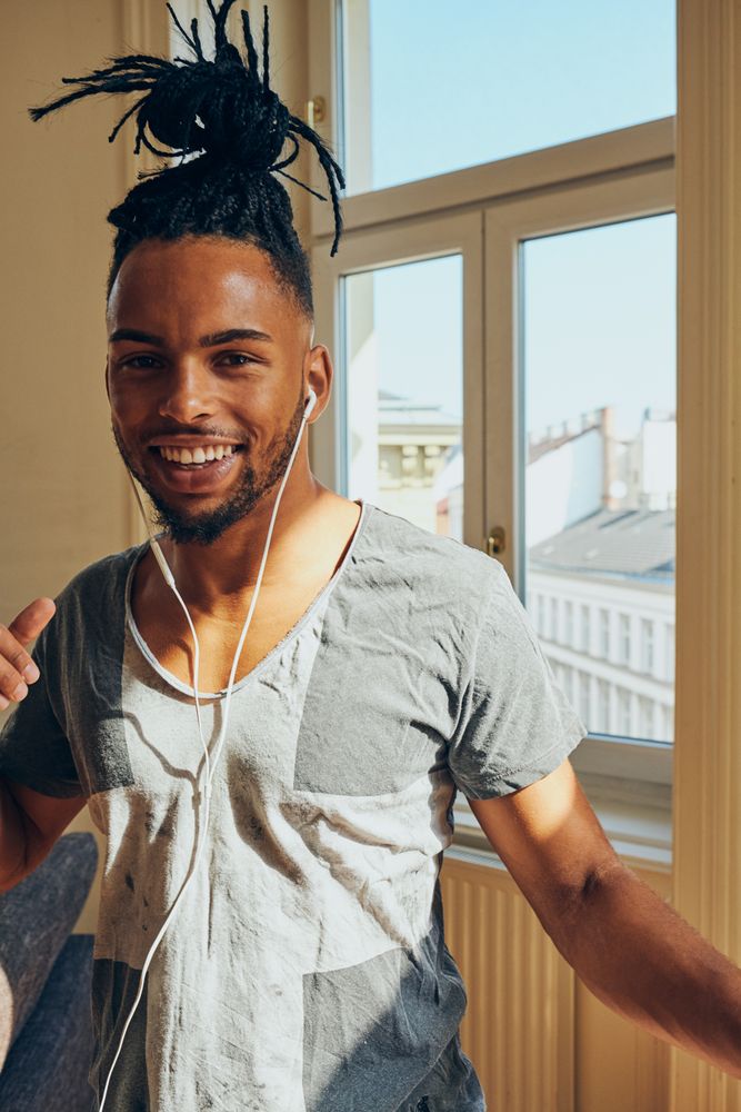 Cheerful Black male listening to music