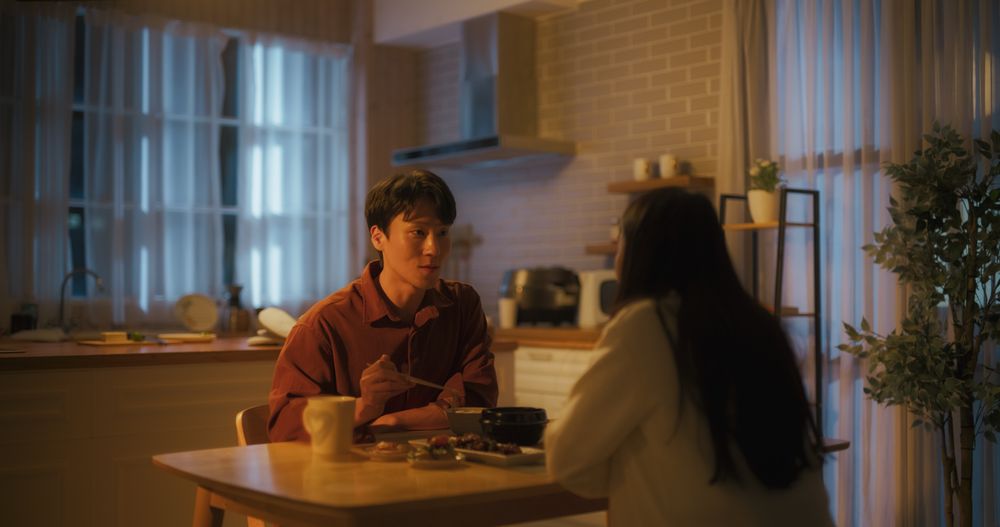 South Korean Young Couple Cooked Dinner at Home and Eating Food Together in the Kitchen.