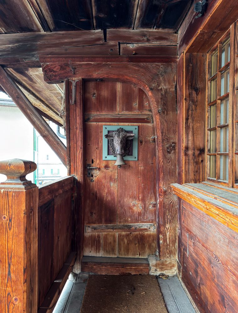 Cow bell knocker chalet door in Rossiniere, VD