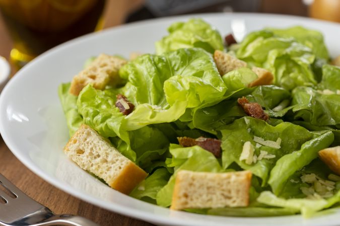 Caesar salad with croutons and bacon.