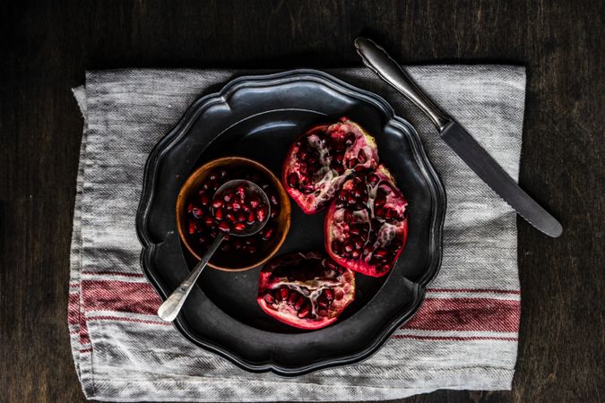 Fresh cut pomegranate on dark bowl