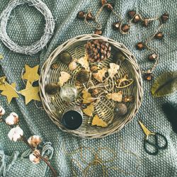 Top view of basket of Christmas decorations on blanket