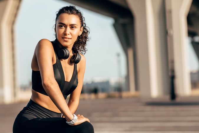 Content woman looking off in the distance in exercise gear