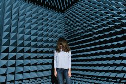 Woman in middle of sound room shaking head