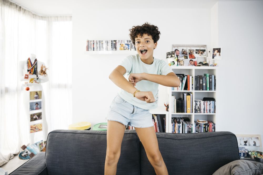 Girl dancing on a sofa