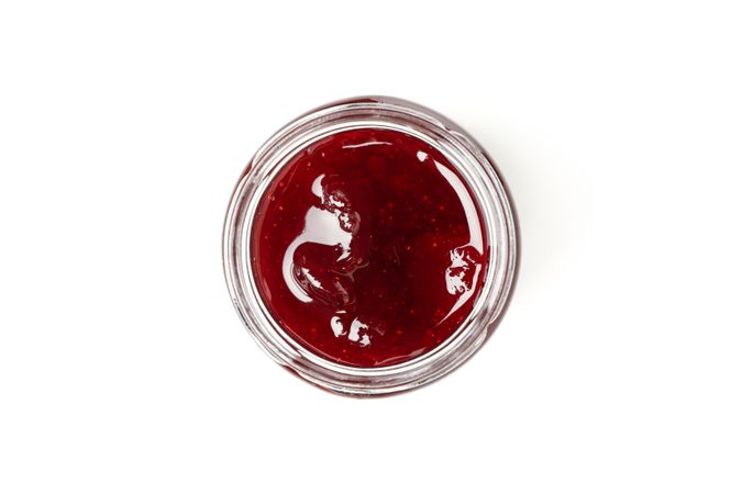 Delicious strawberry jam isolated on plain background