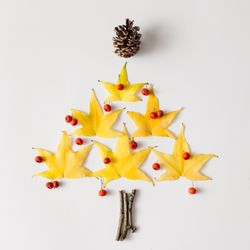 Christmas tree made of yellow leaves and red berries