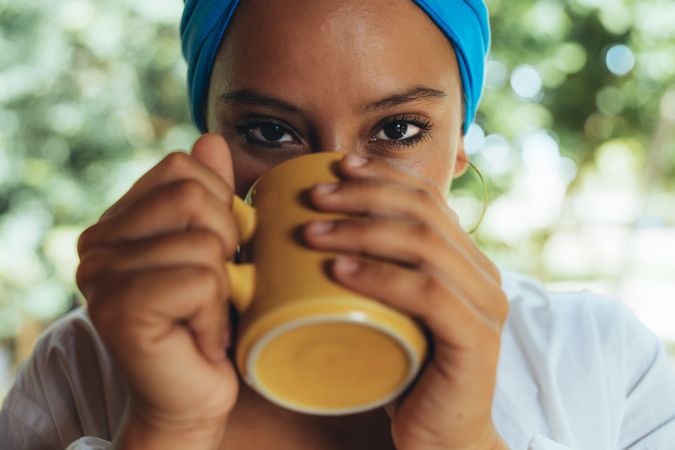 Woman in turban drinking coffee