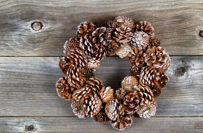 Christmas pine cone wreath on aged Wood
